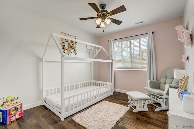 9643 Yukon Way, Colorado Springs, CO 80925 - bedroom featuring wood finished floors, baseboards, a crib, and a ceiling fan