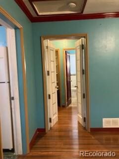 hall with hardwood / wood-style floors and crown molding