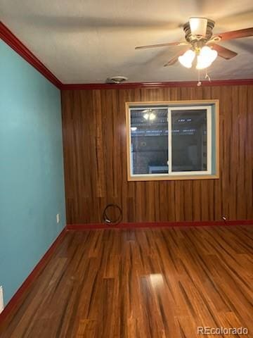 spare room with ceiling fan, ornamental molding, and hardwood / wood-style floors