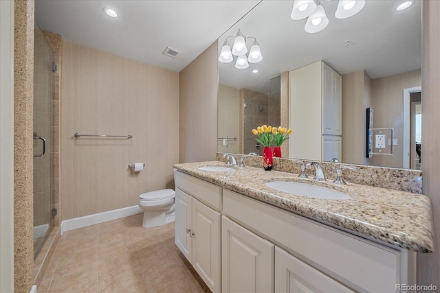 bathroom with tile patterned flooring, vanity, toilet, and a shower with shower door