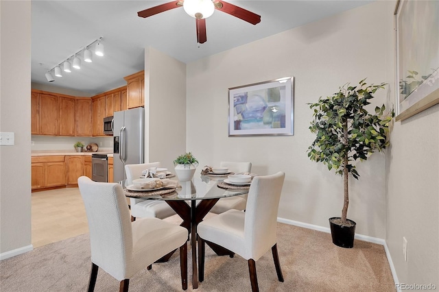 3852 S Dallas St Unit 8-102, Aurora, CO 80014 - dining space featuring light colored carpet, rail lighting, and ceiling fan