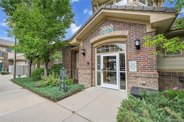 3852 S Dallas St Unit 8-102, Aurora, CO 80014 - view of exterior entry featuring brick siding