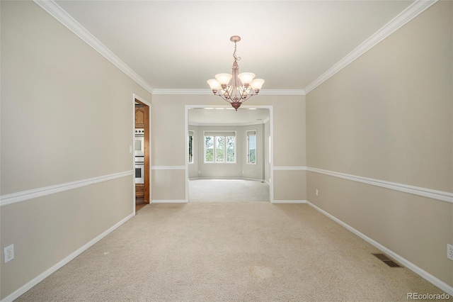 unfurnished room with ornamental molding and a chandelier