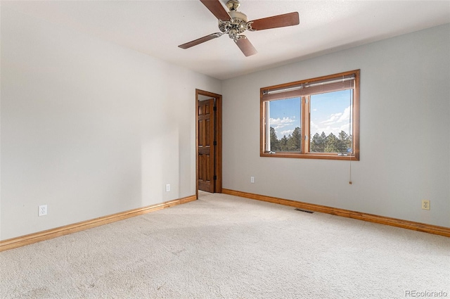 unfurnished room with light colored carpet and ceiling fan