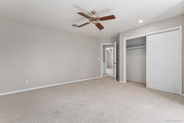 unfurnished bedroom featuring a closet, ceiling fan, and light colored carpet