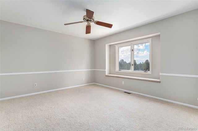 carpeted spare room featuring ceiling fan