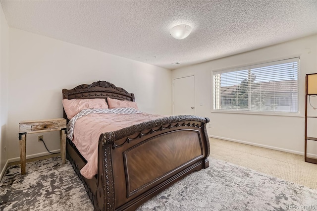 carpeted bedroom featuring a textured ceiling