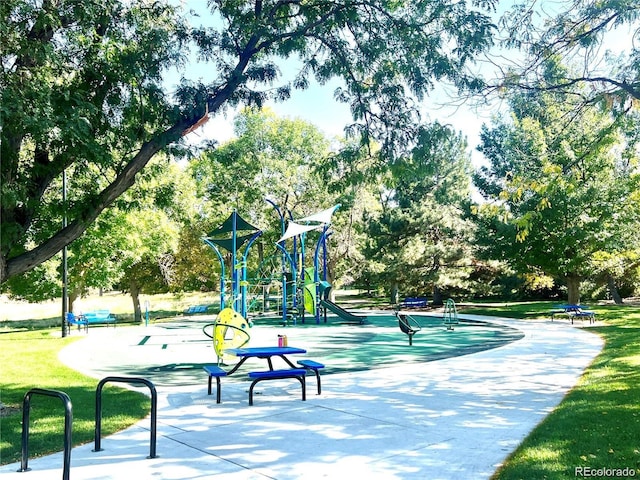 view of home's community featuring a playground and a lawn