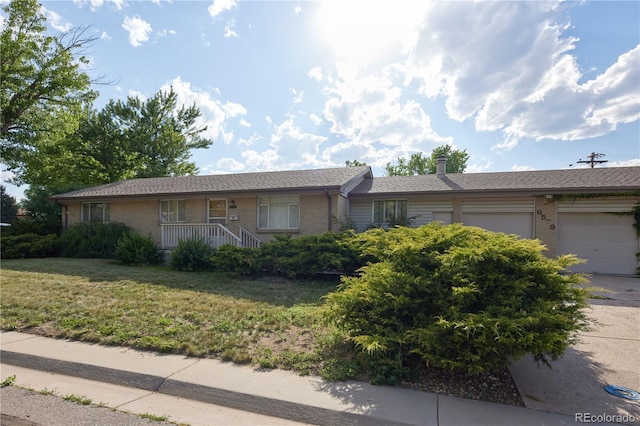6579 S Lincoln St, Centennial, CO 80121 - single story home with brick siding, an attached garage, a front yard, driveway, and a chimney