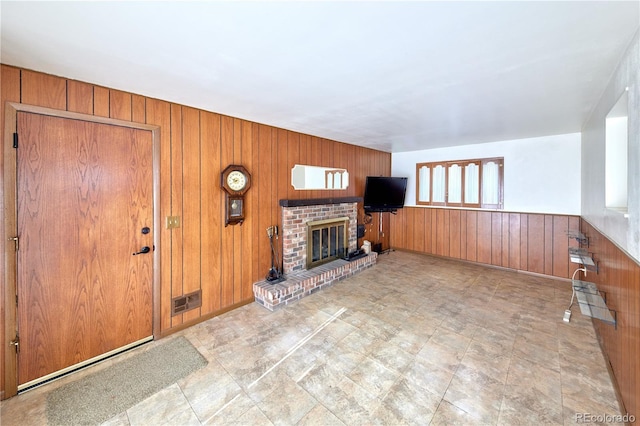 6579 S Lincoln St, Centennial, CO 80121 - unfurnished living room featuring wooden walls, a brick fireplace, a wainscoted wall, and tile patterned floors