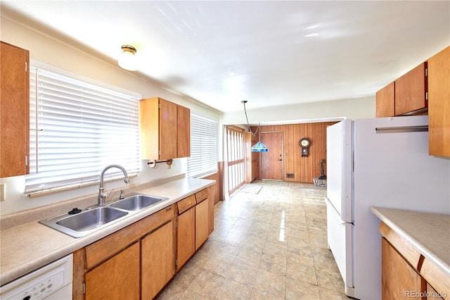6579 S Lincoln St, Centennial, CO 80121 - kitchen featuring white appliances, light countertops, hanging light fixtures, and brown cabinets