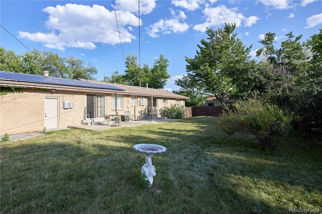 6579 S Lincoln St, Centennial, CO 80121 - back of house with a patio, roof mounted solar panels, and brick siding