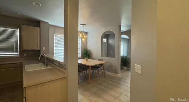1254 Carlyle Park Cir, Highlands Ranch, CO 80129 - kitchen featuring arched walkways, light tile patterned flooring, and pendant lighting