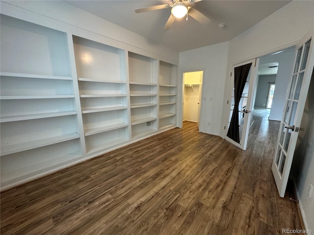 unfurnished room featuring ceiling fan, baseboards, and dark wood-style flooring