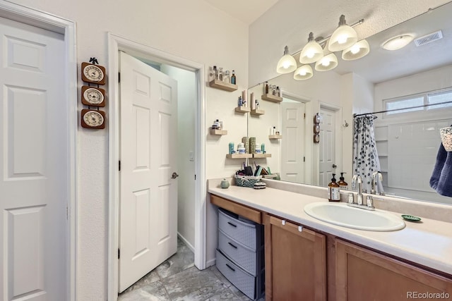 full bathroom with visible vents, vanity, and a shower with shower curtain