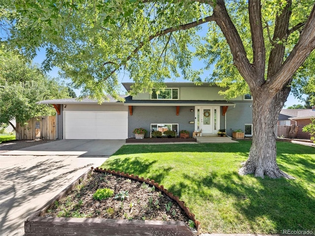 view of front of house featuring driveway, a garage, fence, and a front lawn