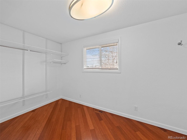 spacious closet with wood finished floors