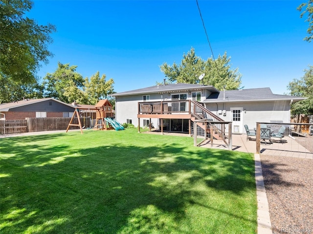 rear view of house featuring a patio, a playground, a fenced backyard, a lawn, and stucco siding