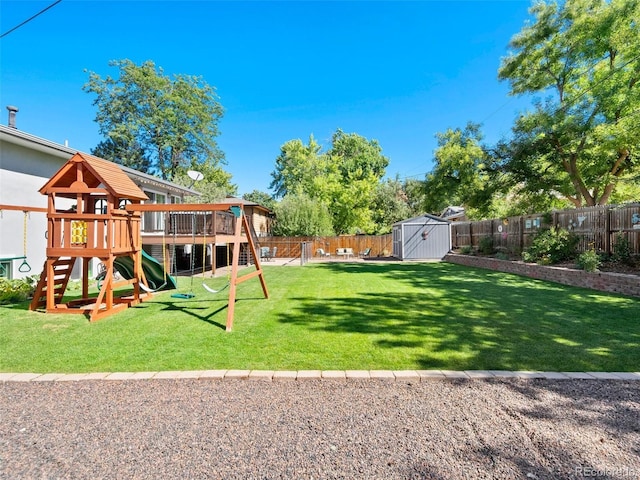 view of yard with a storage shed, a playground, a fenced backyard, and an outdoor structure