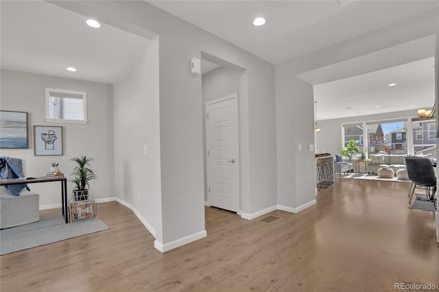 interior space featuring recessed lighting, visible vents, baseboards, and wood finished floors