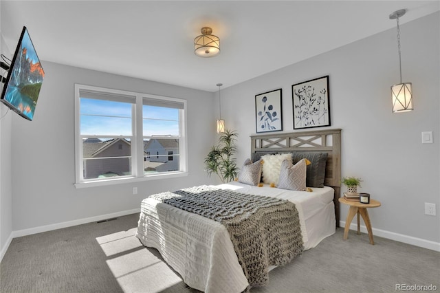 carpeted bedroom with baseboards and visible vents