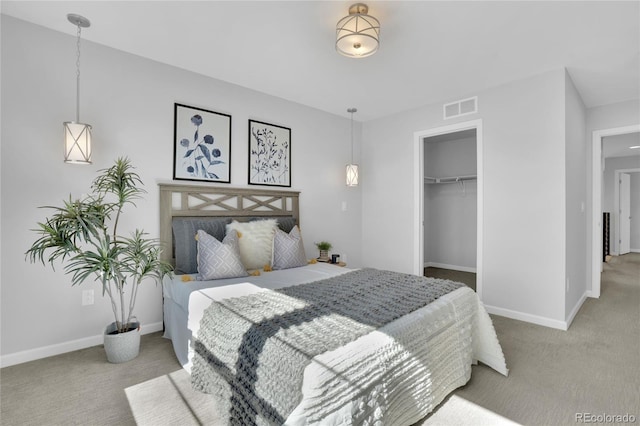 carpeted bedroom with baseboards and visible vents