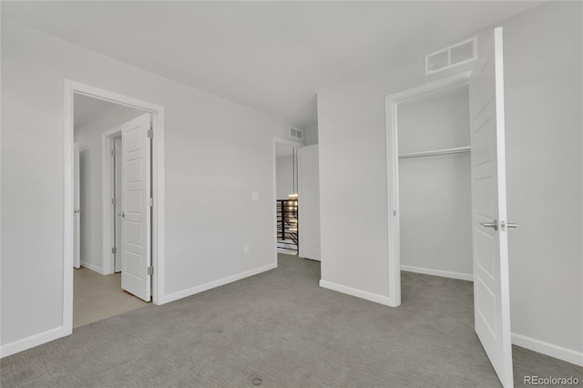 unfurnished bedroom featuring carpet, visible vents, and baseboards