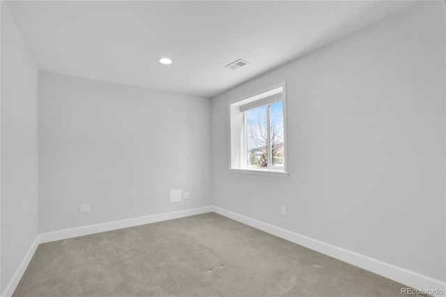 carpeted empty room with recessed lighting, visible vents, and baseboards