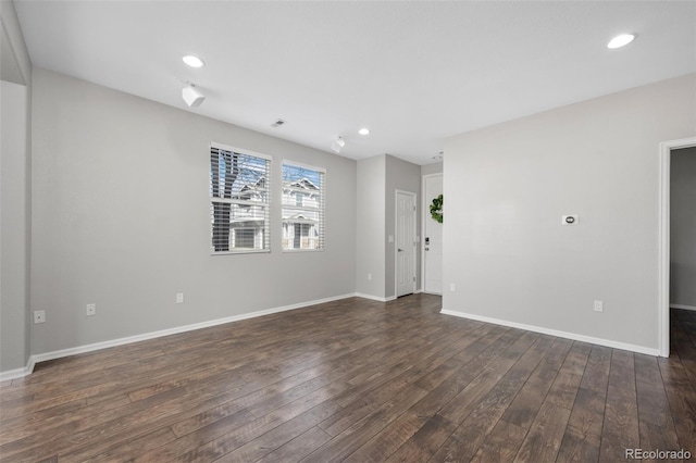 unfurnished room featuring baseboards, dark wood-style flooring, and recessed lighting