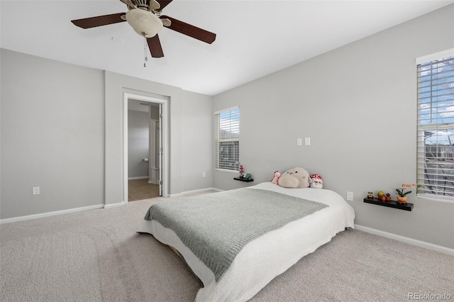 carpeted bedroom featuring ceiling fan and baseboards