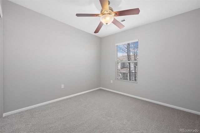 carpeted empty room with visible vents, baseboards, and ceiling fan