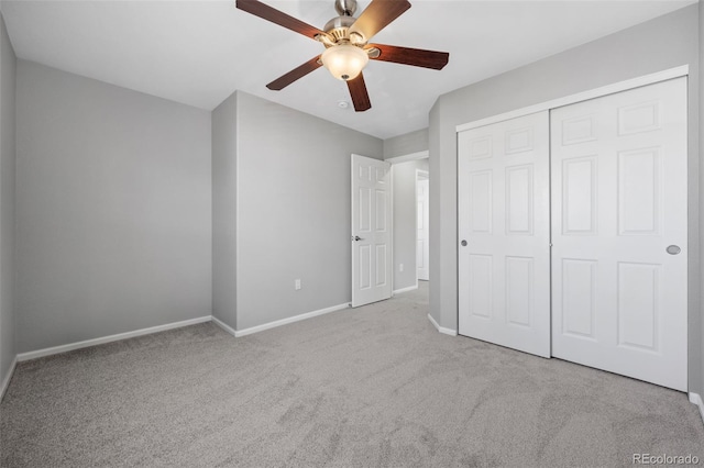 unfurnished bedroom featuring a ceiling fan, carpet, a closet, and baseboards