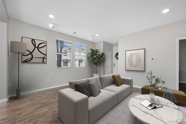 living room featuring baseboards, wood finished floors, and recessed lighting