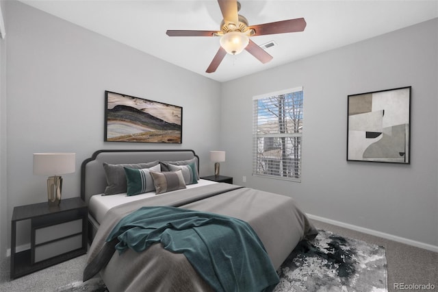 carpeted bedroom featuring a ceiling fan, visible vents, and baseboards