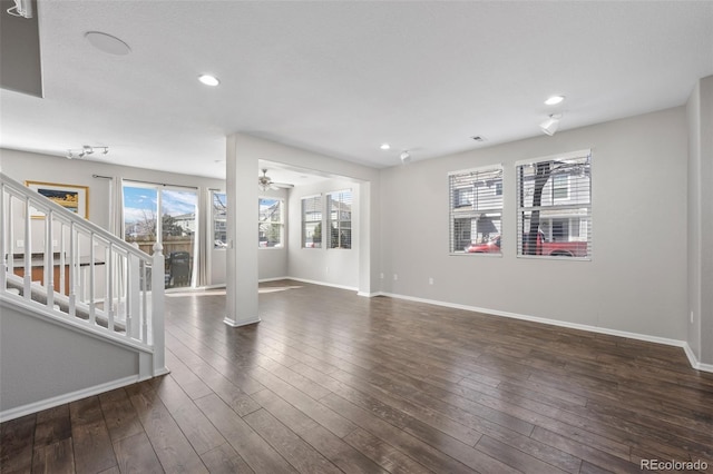 unfurnished living room with stairs, recessed lighting, dark wood finished floors, and baseboards