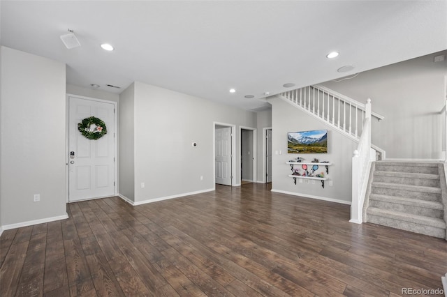 unfurnished living room featuring stairs, recessed lighting, hardwood / wood-style flooring, and baseboards