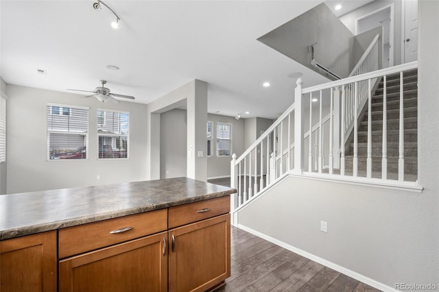 kitchen with a wealth of natural light, dark wood-style flooring, and brown cabinets