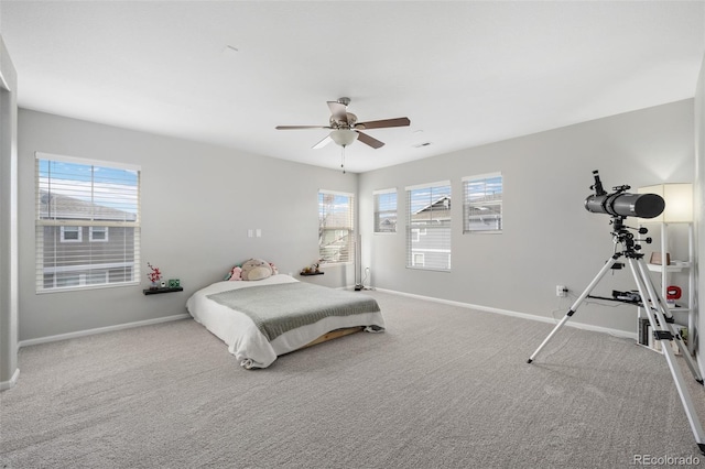 bedroom with ceiling fan, carpet, and baseboards