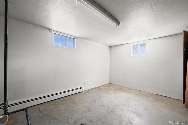 2704 S Ames Way, Denver, CO 80227 - below grade area with baseboard heating, plenty of natural light, and a textured ceiling