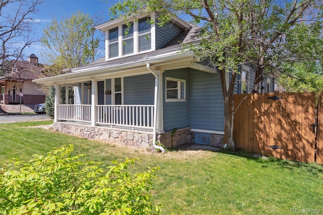 5101 Meade St, Denver, CO 80221 - bungalow with covered porch, fence, and a front lawn