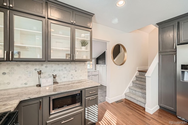 5101 Meade St, Denver, CO 80221 - bar with wood finished floors, baseboards, backsplash, appliances with stainless steel finishes, and stairs