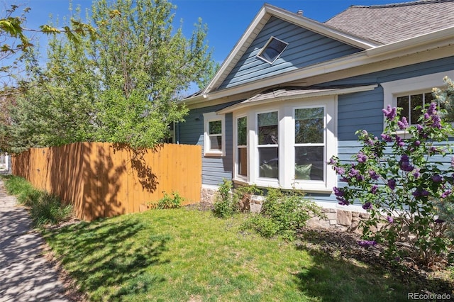 5101 Meade St, Denver, CO 80221 - view of side of property featuring a yard, roof with shingles, and fence