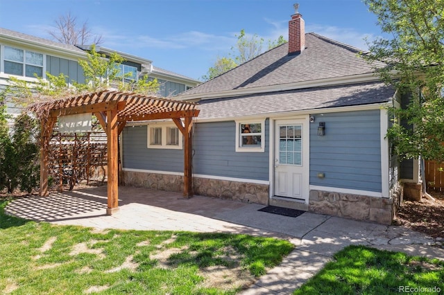 5101 Meade St, Denver, CO 80221 - rear view of house featuring a patio area, fence, stone siding, a pergola, and a chimney