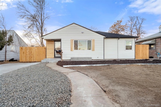 view of front of property with brick siding and fence