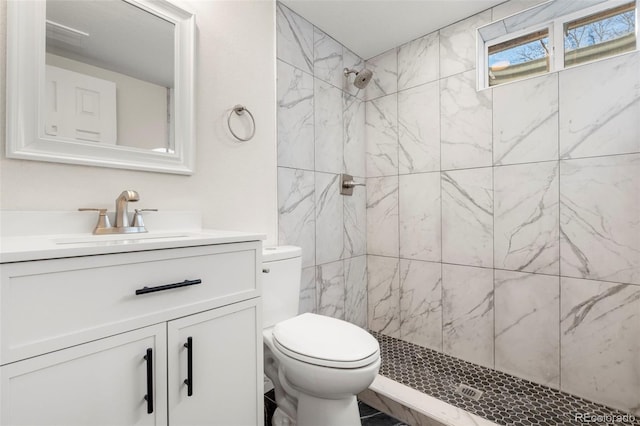 full bathroom featuring a stall shower, vanity, and toilet