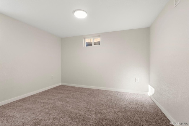 carpeted empty room with baseboards