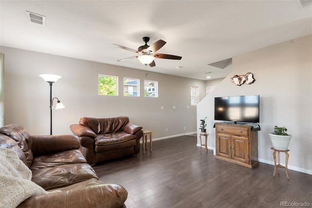 living area featuring visible vents, dark wood finished floors, baseboards, and ceiling fan