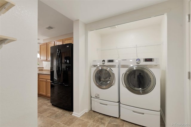 laundry room with laundry area, visible vents, and washer and dryer