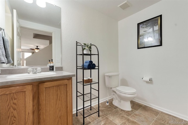 bathroom featuring baseboards, visible vents, vanity, and toilet