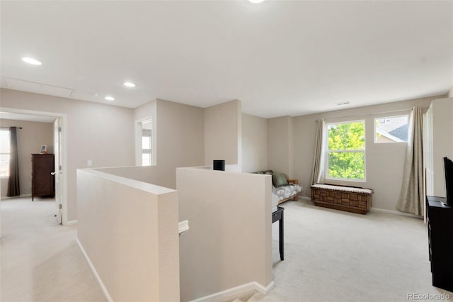 hallway with baseboards, recessed lighting, an upstairs landing, and light colored carpet